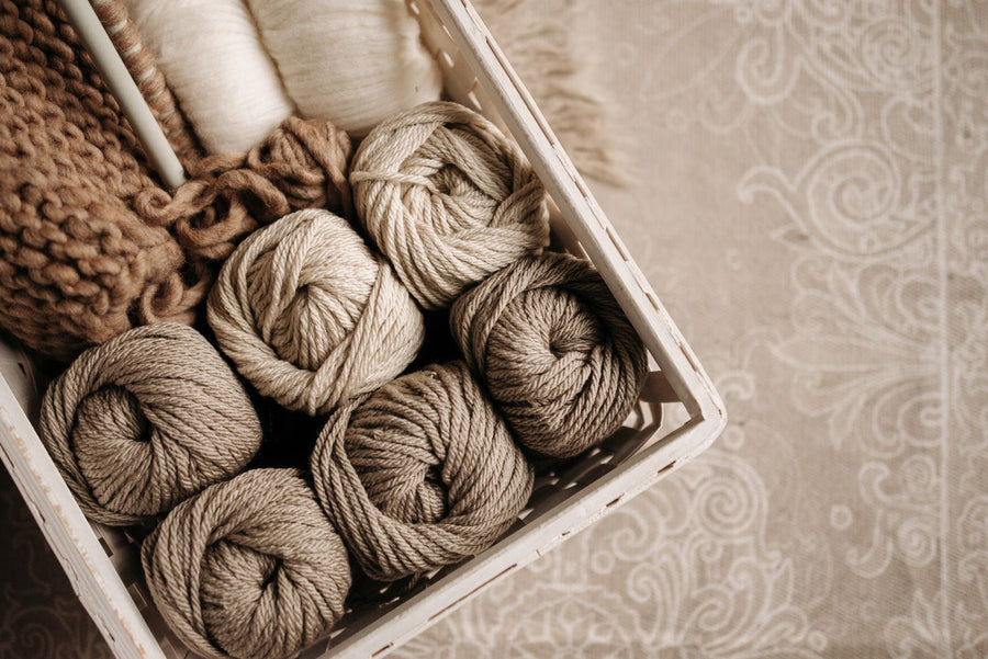 Neutral yarn skeins in a crate
